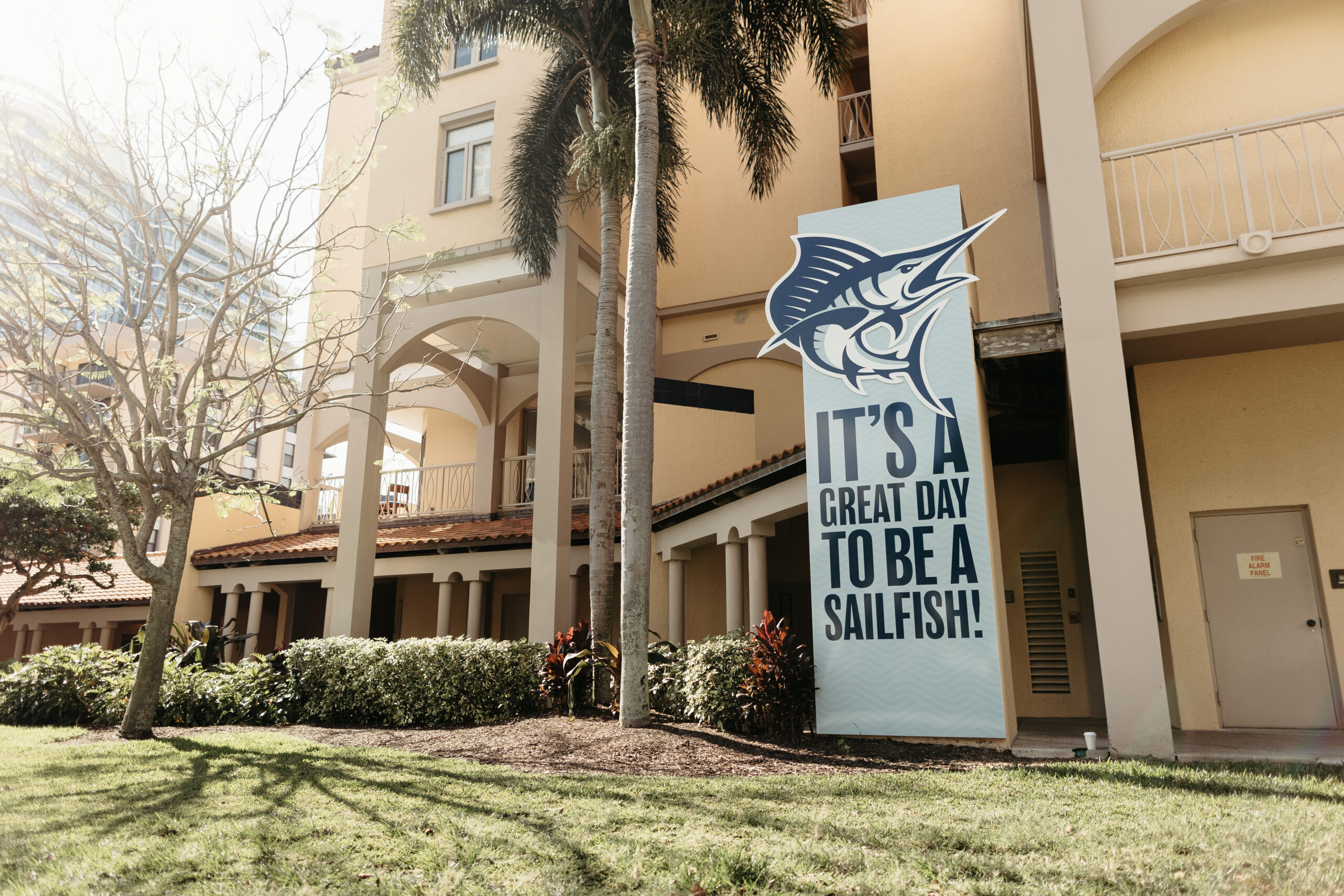 a sign saying "its a great day to be a sailfish" in front of a PBA building