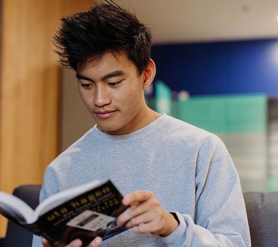History student reads a book in the dorms.