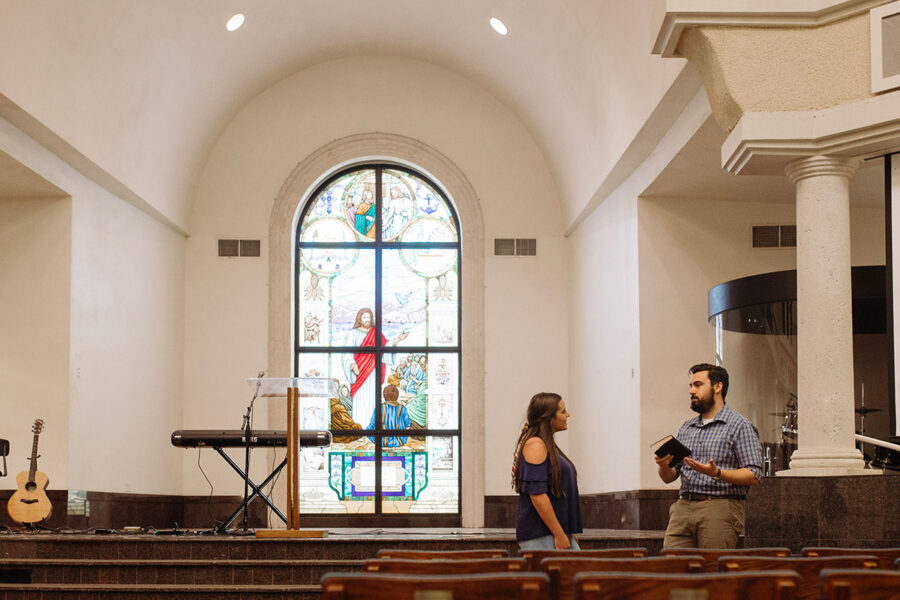 ministry student in the chapel providing counsel to another student