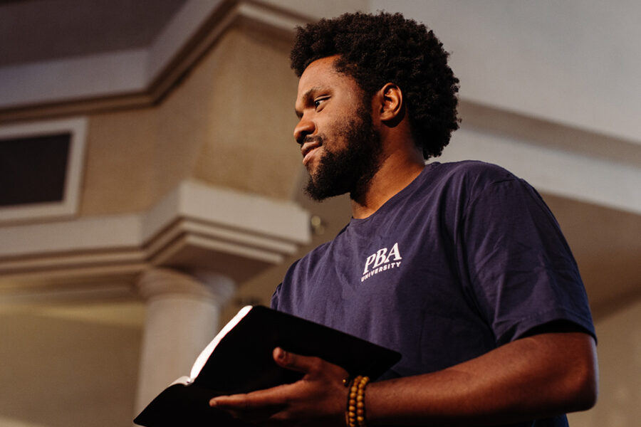 PBA student holds a bible in chapel.