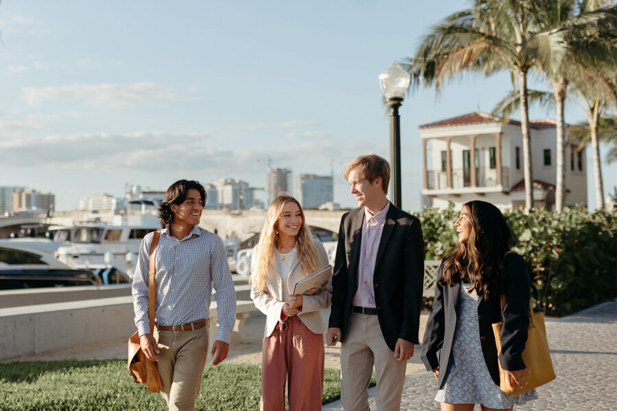 master of business administration mba students walk near the intercoastal waterway in West Palm Beach.